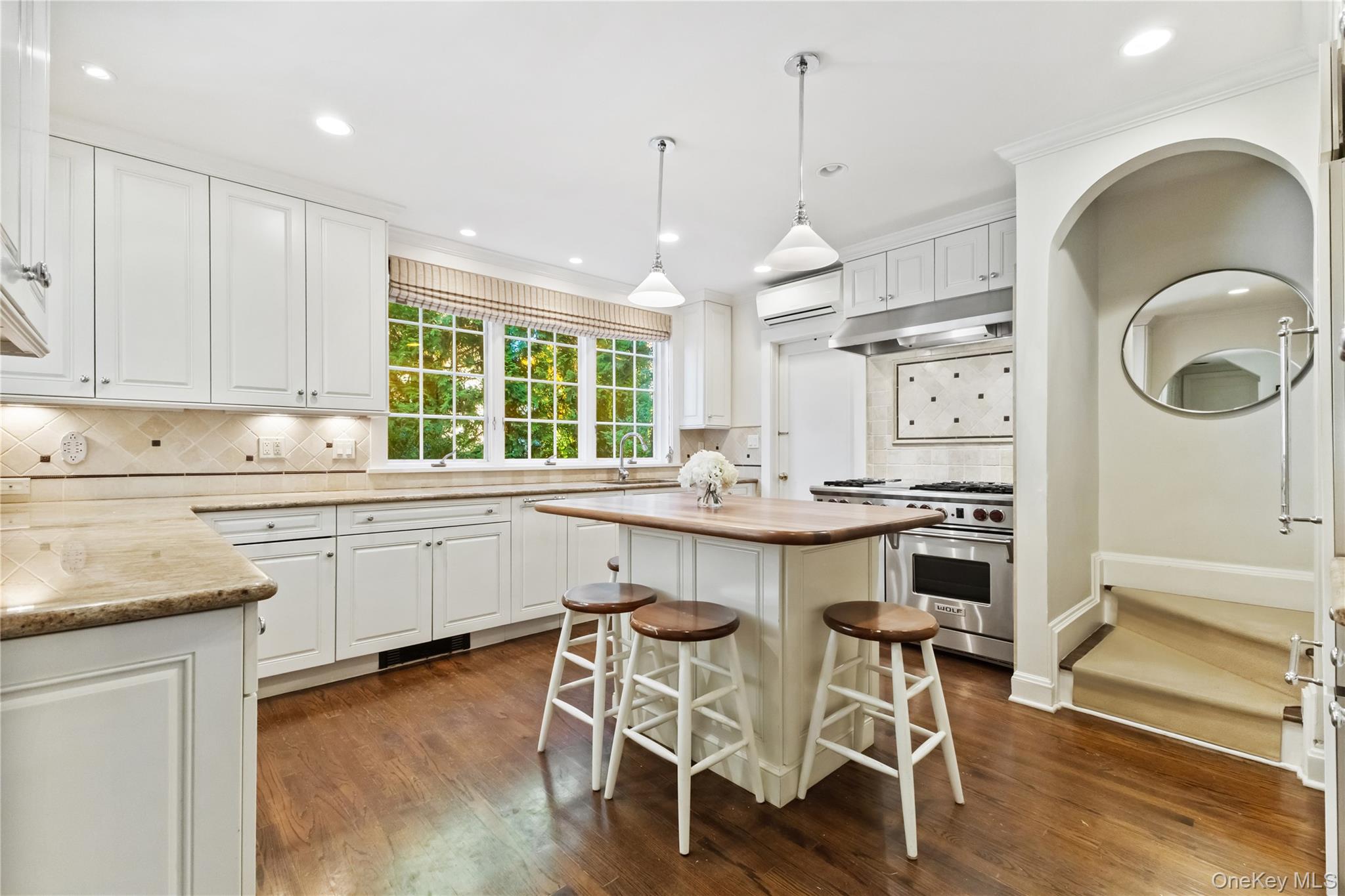30 Studio Lane Bronxville, NY 10708 - Photo 16 of 30 a kitchen with granite countertop a stove a sink a dining table and chairs with wooden floor