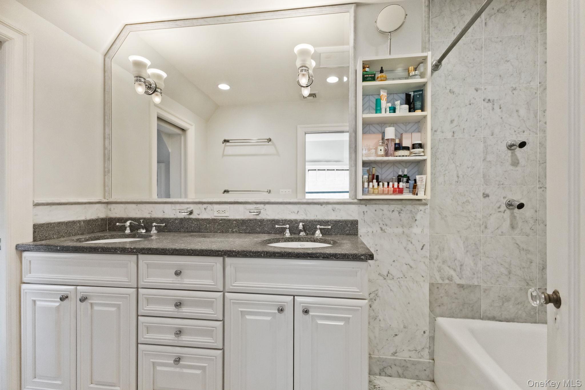 30 Studio Lane Bronxville, NY 10708 - Photo 24 of 30 a bathroom with a granite countertop sink a mirror and a bathtub