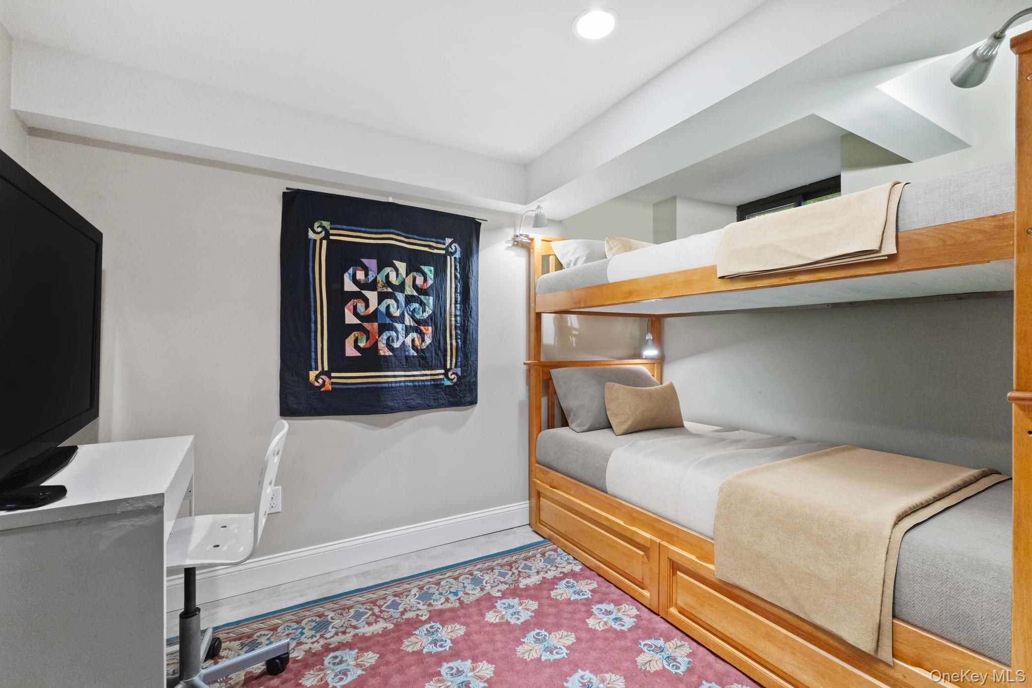 30 Studio Lane Bronxville, NY 10708 - Photo 27 of 30 a bedroom with a bed and a flat screen tv