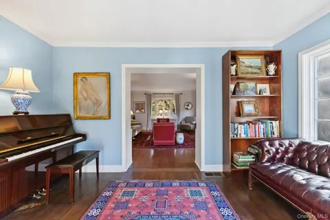 a living room with furniture and a book shelf