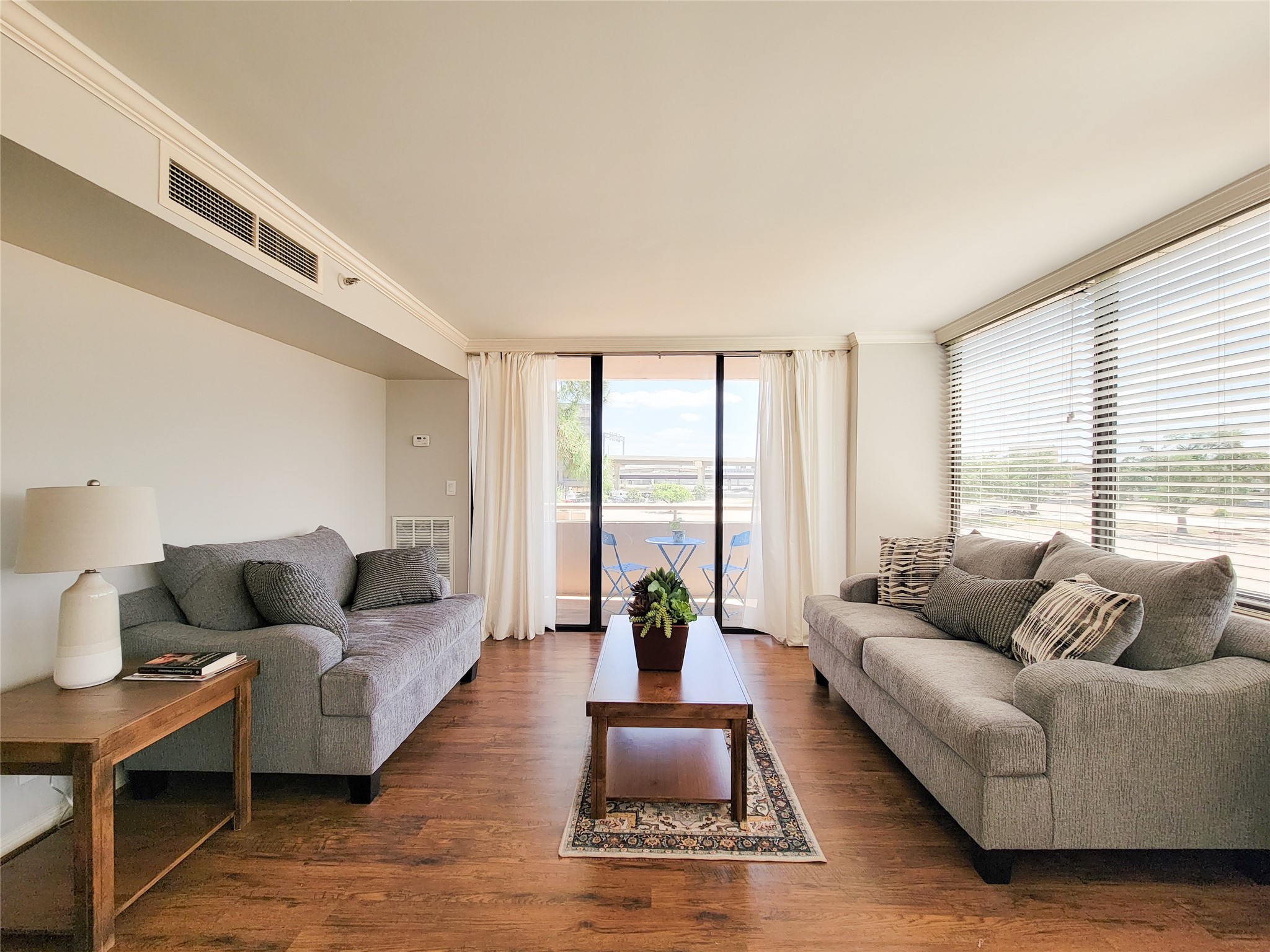 3525 Sage Road, Unit 303 Houston, TX 77056 - Photo 18 of 41 Living area with view to the balcony! Rich, shining laminate flooring! Beautiful window coverings and lots of natural light.