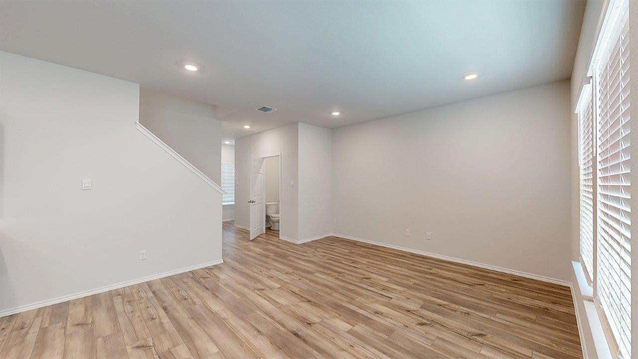557 Hector Loop Georgetown, TX 78626 - Photo 19 of 38 Open-concept living area featuring wood-finish flooring, recessed lighting, and a neutral color palette