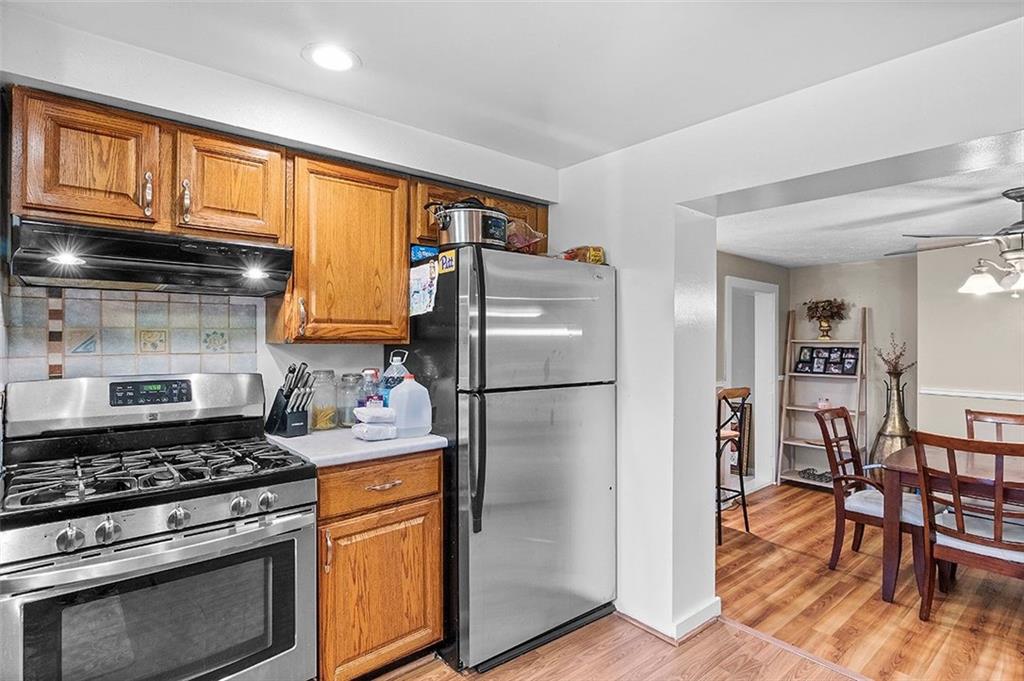 33 Radium Street Pittsburgh, PA 15214 - Photo 12 of 31 a kitchen with stainless steel appliances granite countertop a stove a refrigerator and a wooden cabinets