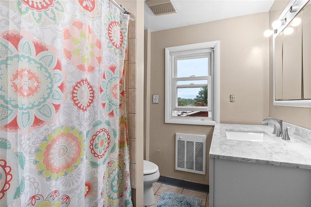 33 Radium Street Pittsburgh, PA 15214 - Photo 27 of 31 a bathroom with a granite countertop sink and a mirror