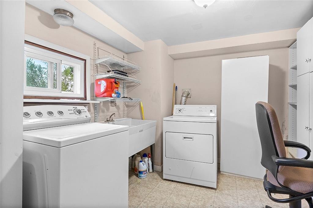 33 Radium Street Pittsburgh, PA 15214 - Photo 28 of 31 a utility room with dryer washer and a window