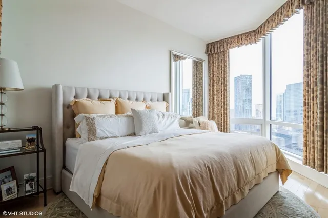 a bedroom with a bed and a large window