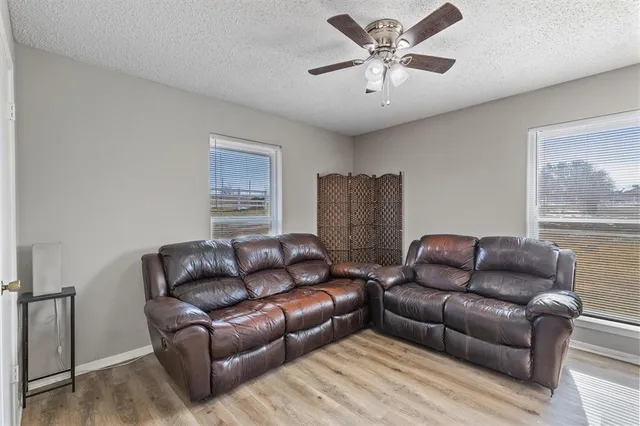 a bathroom with a granite countertop sink a mirror and a bathtub