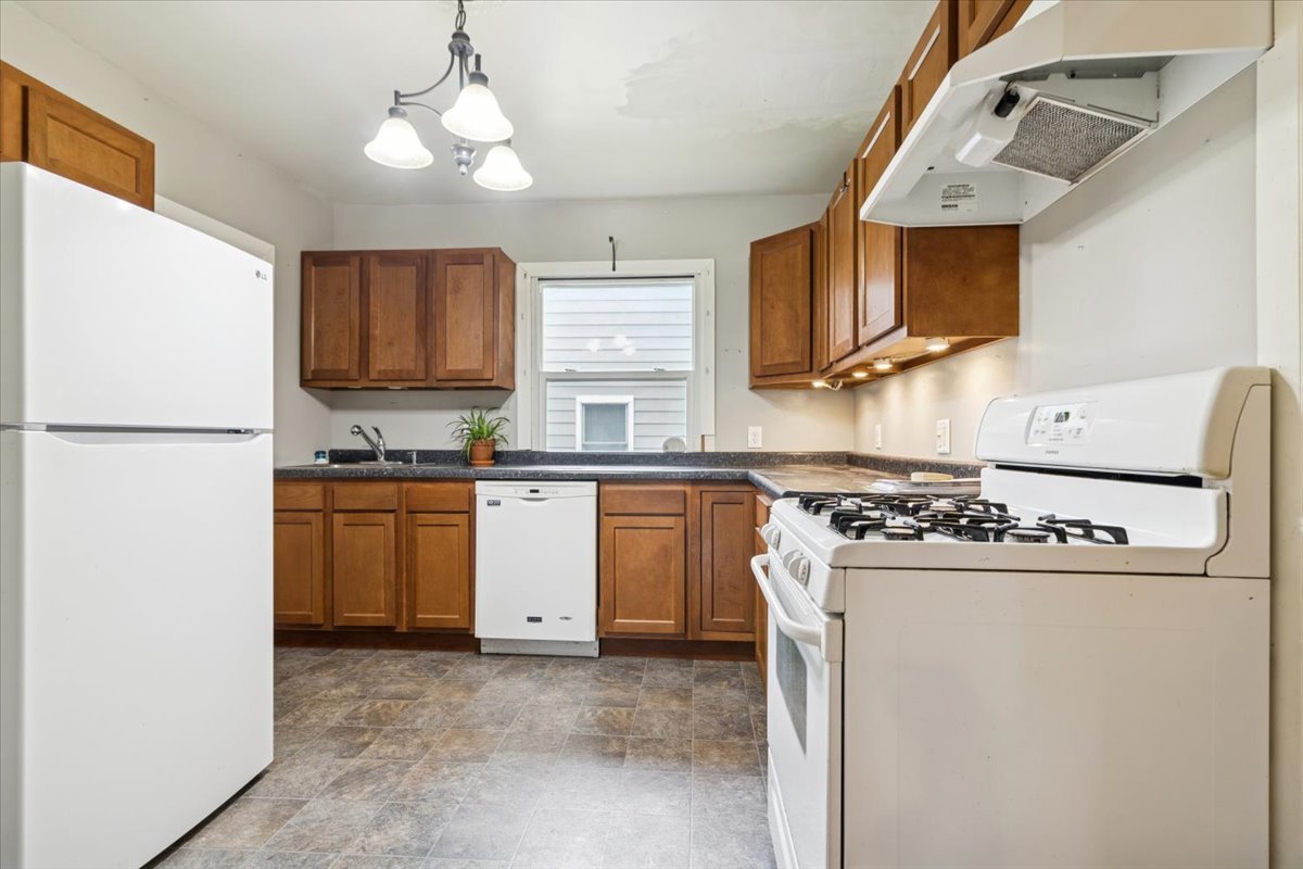 310 South Sycamore Street Genoa, IL 60135 - Photo 11 of 21 a kitchen with stove cabinets and refrigerator