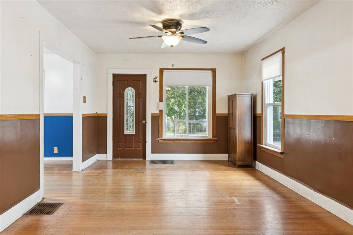 310 South Sycamore Street Genoa, IL 60135 - Photo 4 of 21 a view of an empty room with window chandelier fan