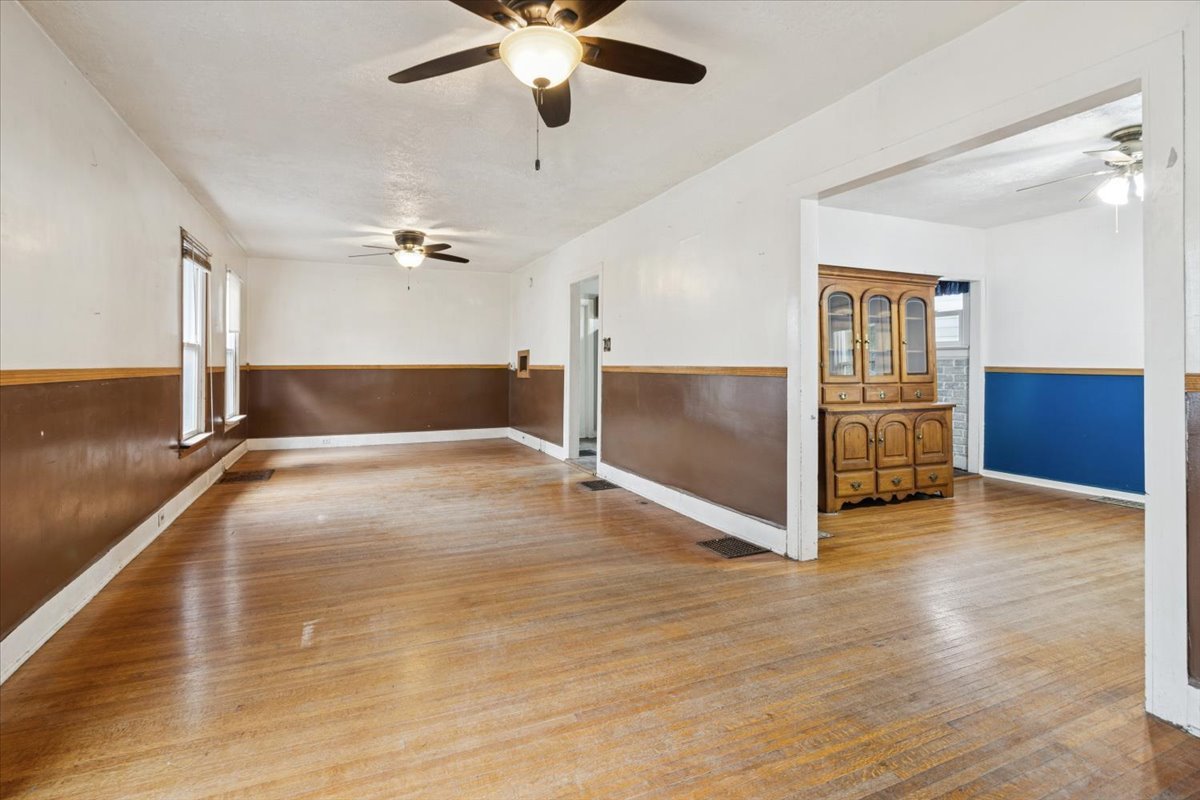 310 South Sycamore Street Genoa, IL 60135 - Photo 7 of 21 wooden floor in an empty room with a window