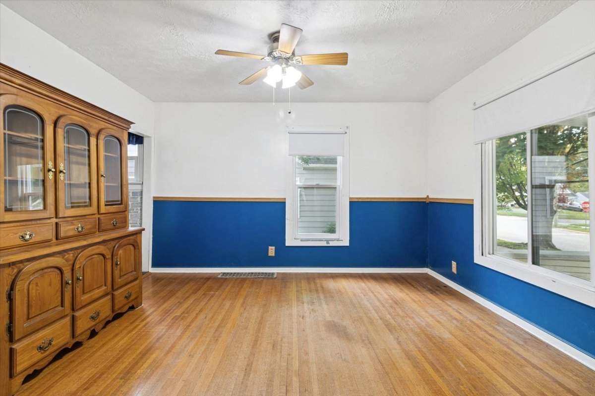 310 South Sycamore Street Genoa, IL 60135 - Photo 8 of 21 a view of a livingroom with wooden floor and an empty space