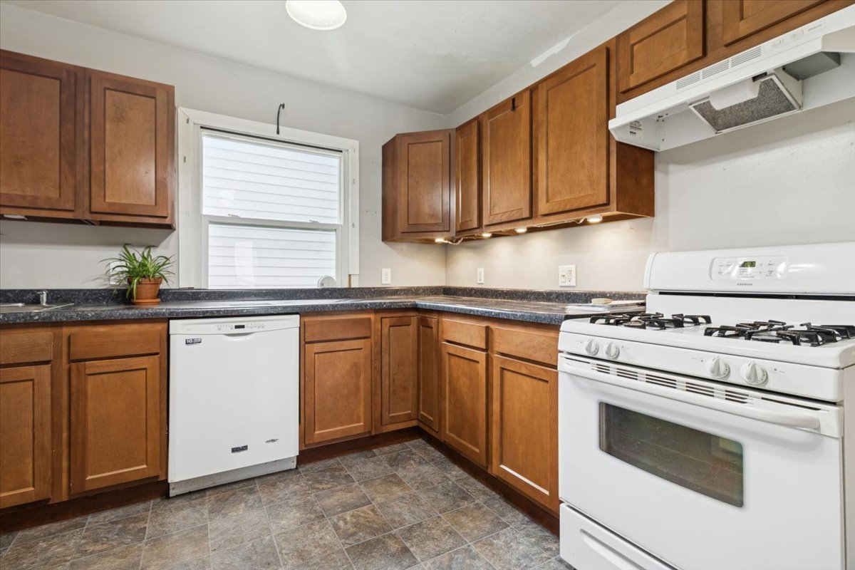310 South Sycamore Street Genoa, IL 60135 - Photo 10 of 21 a kitchen with cabinets appliances a sink and a window