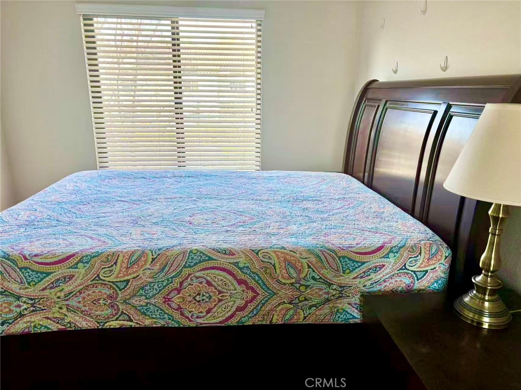 18 Town And Country Road, Unit 34 Pomona, CA 91766 - Photo 11 of 26 a bedroom with a bed and wooden floor