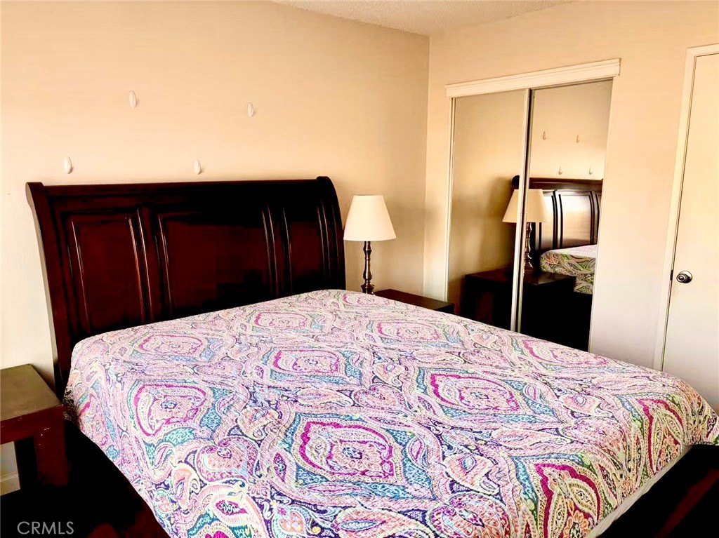 18 Town And Country Road, Unit 34 Pomona, CA 91766 - Photo 12 of 26 a bedroom with a bed and a dresser