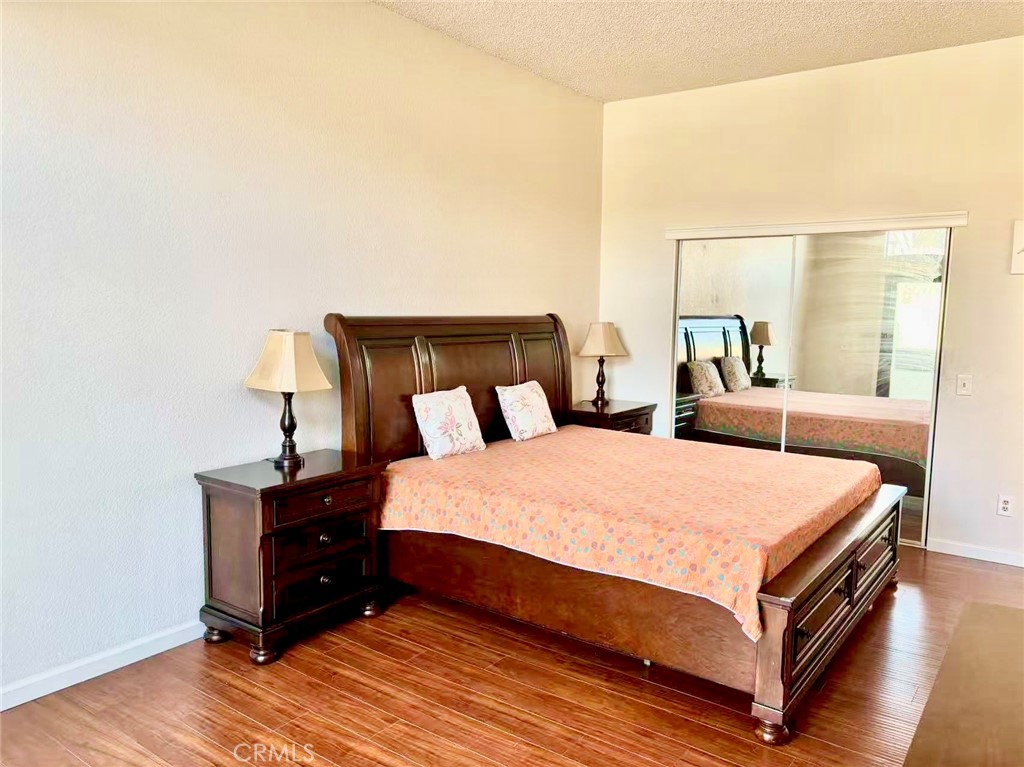 18 Town And Country Road, Unit 34 Pomona, CA 91766 - Photo 13 of 26 a bed room with a bed and a night stand