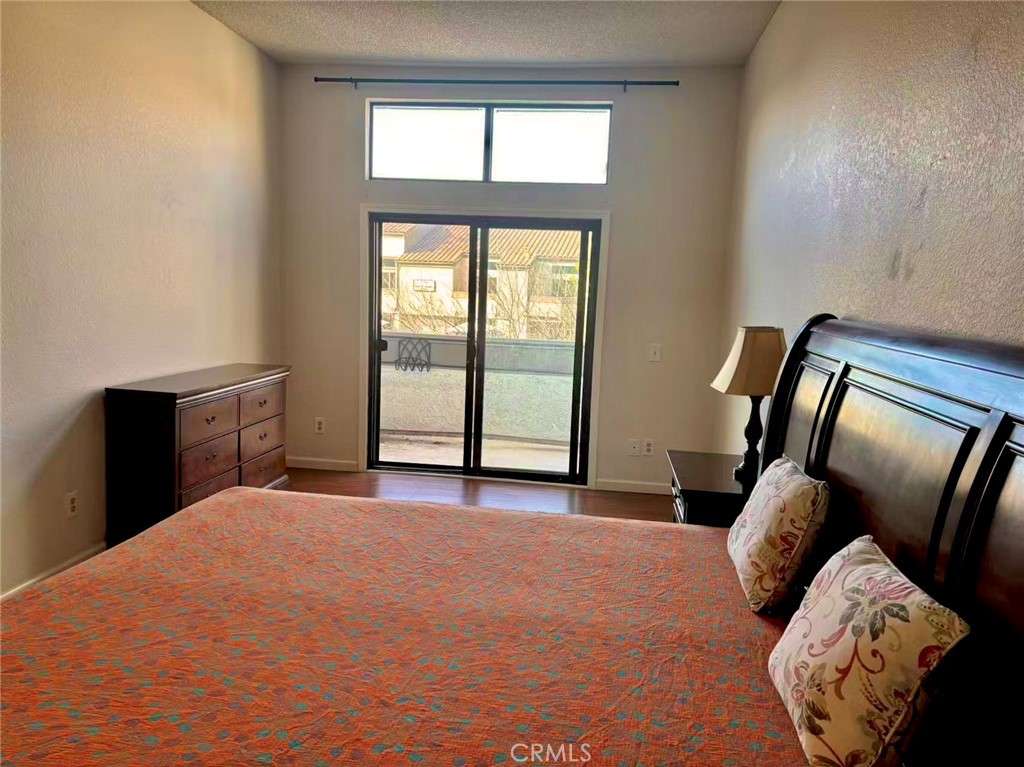 18 Town And Country Road, Unit 34 Pomona, CA 91766 - Photo 14 of 26 a large bed sitting in a bedroom next to a window