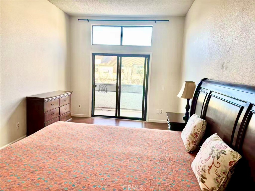 18 Town And Country Road, Unit 34 Pomona, CA 91766 - Photo 15 of 26 a large bed sitting in a bedroom next to a window