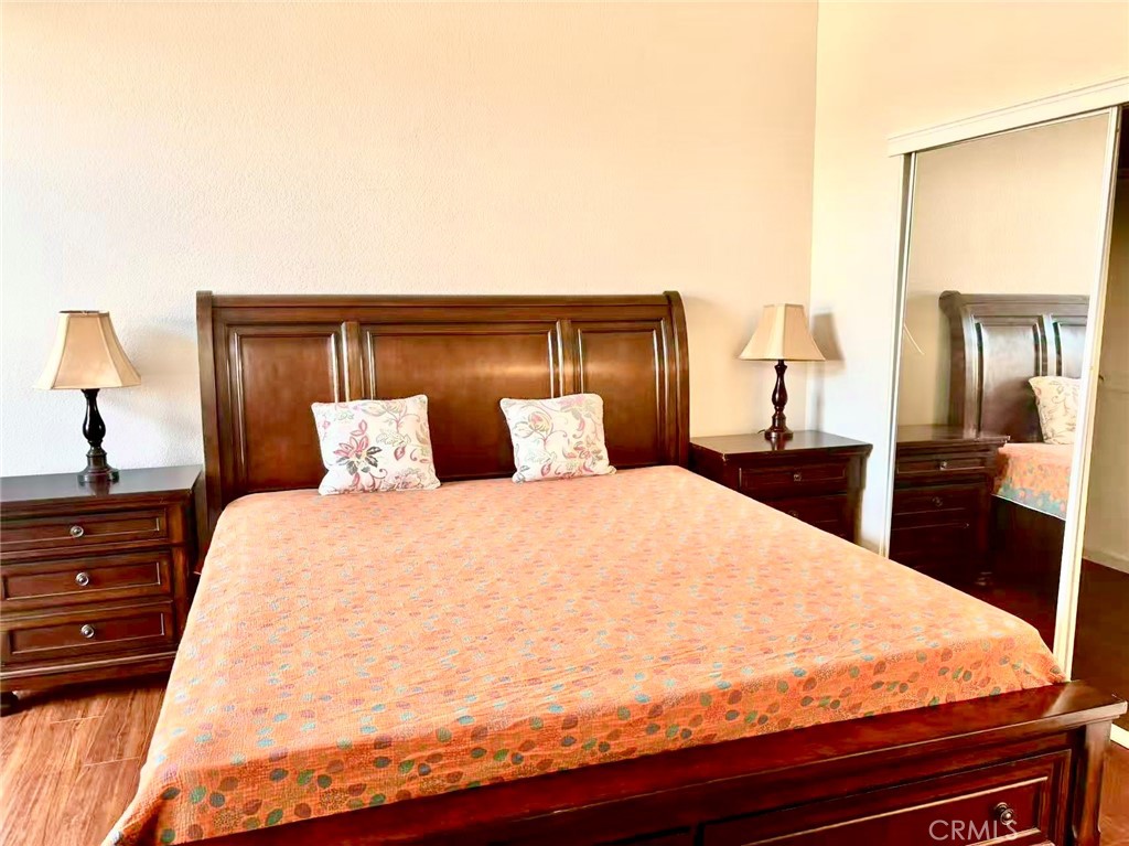 18 Town And Country Road, Unit 34 Pomona, CA 91766 - Photo 16 of 26 a large bed sitting in a bedroom and dressers next to a larger window