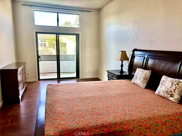 a bedroom with a large bed and a large window