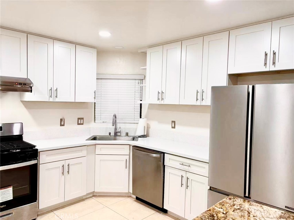 18 Town And Country Road, Unit 34 Pomona, CA 91766 - Photo 19 of 26 a kitchen with white cabinets and white appliances