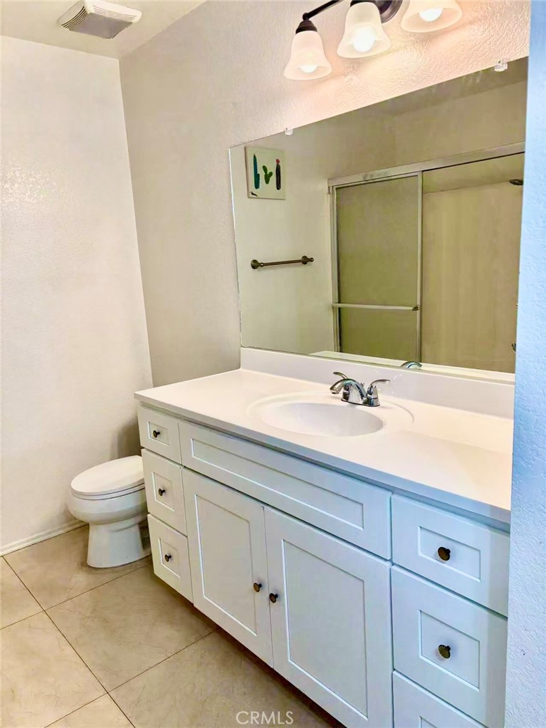 18 Town And Country Road, Unit 34 Pomona, CA 91766 - Photo 21 of 26 a bathroom with a sink a toilet and mirror