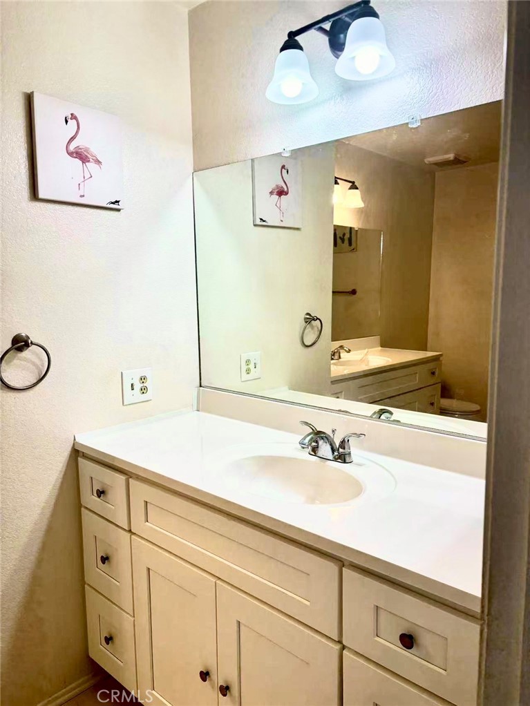 18 Town And Country Road, Unit 34 Pomona, CA 91766 - Photo 23 of 26 a bathroom with a sink and a mirror