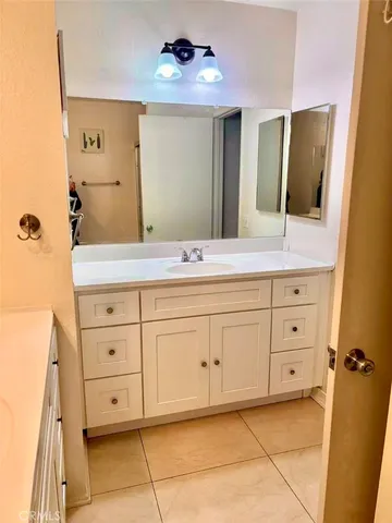 a spacious bathroom with a double vanity sink mirror and