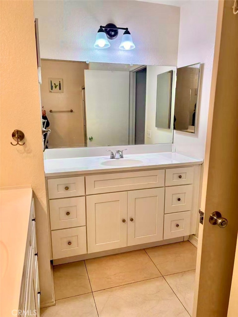 18 Town And Country Road, Unit 34 Pomona, CA 91766 - Photo 25 of 26 a spacious bathroom with a double vanity sink mirror and