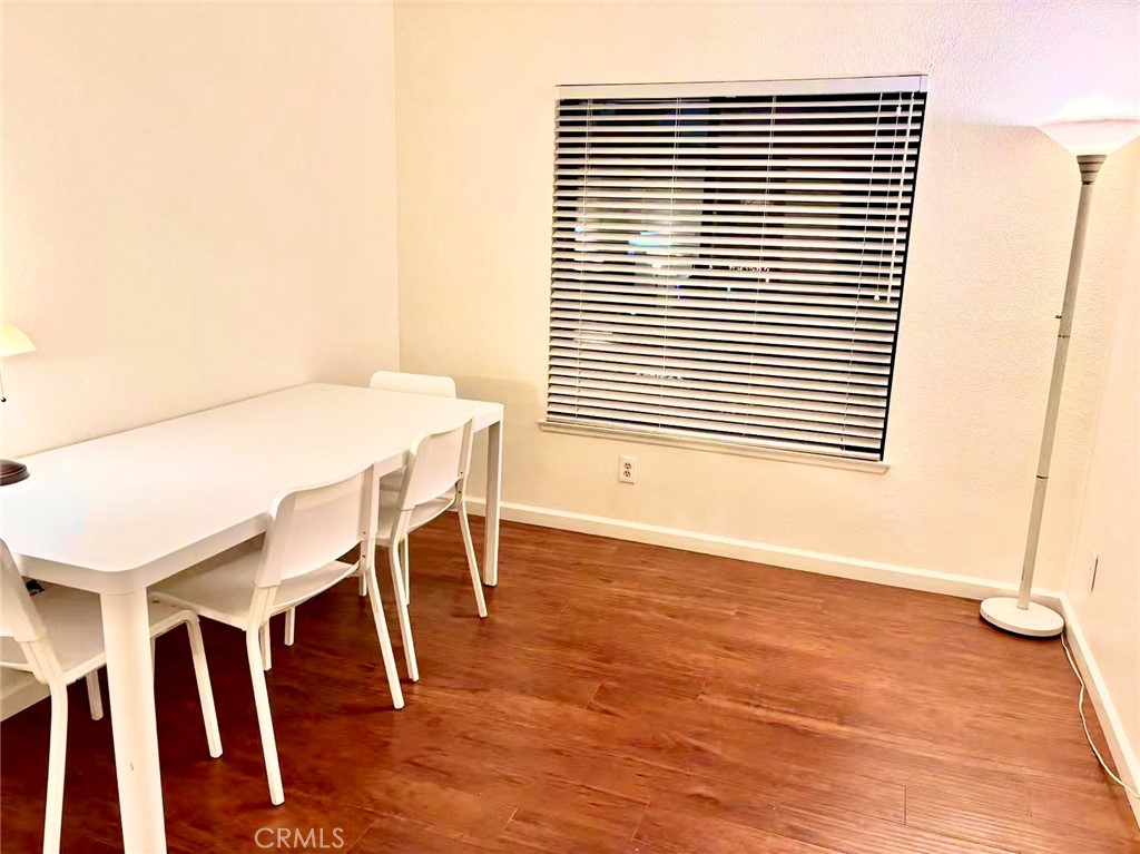 18 Town And Country Road, Unit 34 Pomona, CA 91766 - Photo 8 of 26 a view of a dining room with furniture and wooden floor