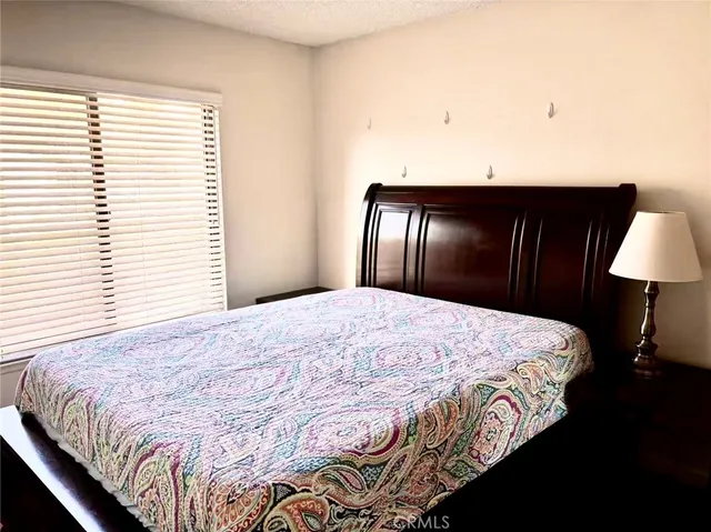 a bedroom with a bed and a lamp