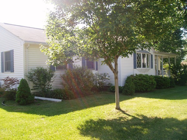 387 Granby Road Chicopee, MA 01013 - Photo 21 of 22 a backyard of a house with plants and large trees