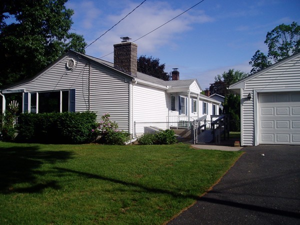 387 Granby Road Chicopee, MA 01013 - Photo 3 of 22 a front view of a house with a yard