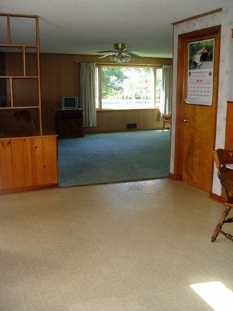 387 Granby Road Chicopee, MA 01013 - Photo 8 of 22 a view of empty room with a fireplace and windows