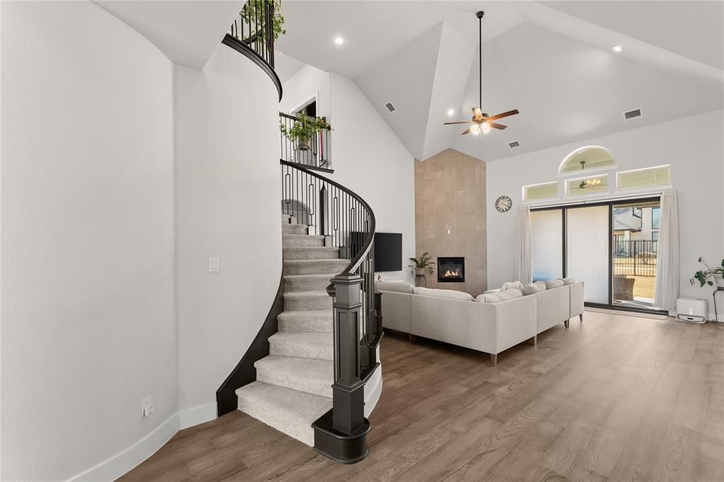 600 St Andrew Lane Prosper, TX 75078 - Photo 12 of 29 Living room featuring a fireplace, wood finished floors, ceiling fan, vaulted ceiling, and recessed lighting
