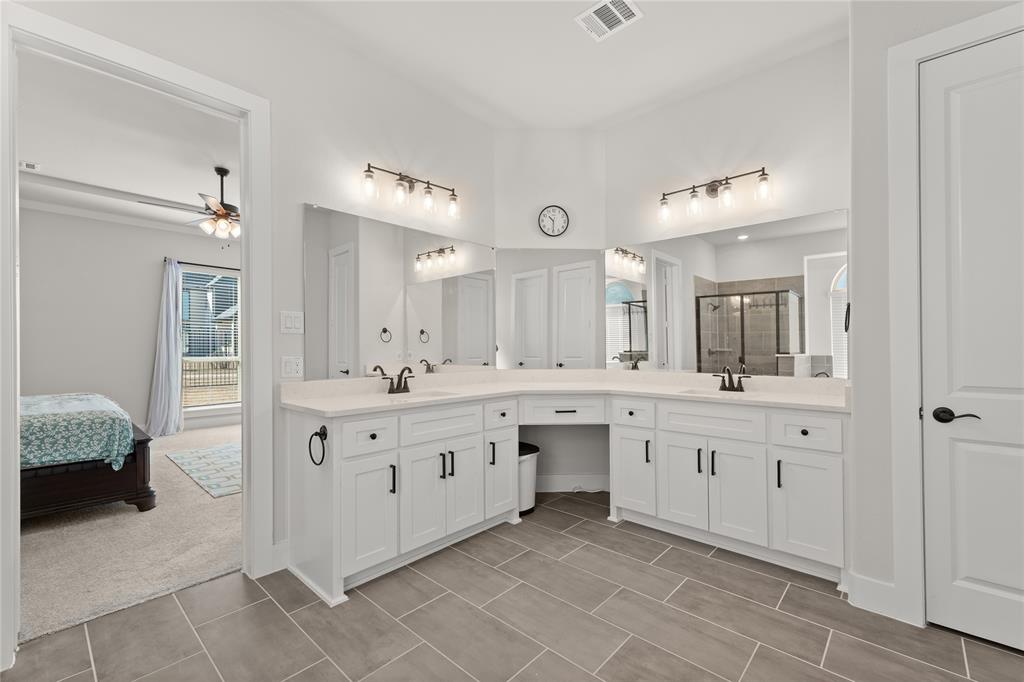 600 St Andrew Lane Prosper, TX 75078 - Photo 17 of 29 Bathroom with a stall shower, double vanity, ensuite bathroom, and ceiling fan