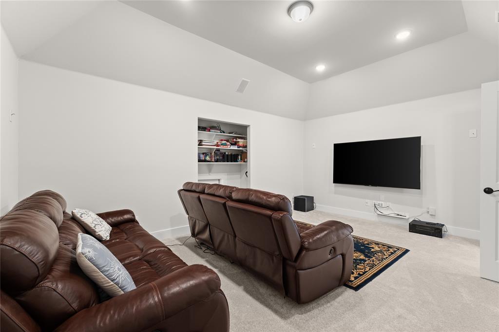 600 St Andrew Lane Prosper, TX 75078 - Photo 20 of 29 Home theater with vaulted ceiling, built in features, light carpet, and recessed lighting