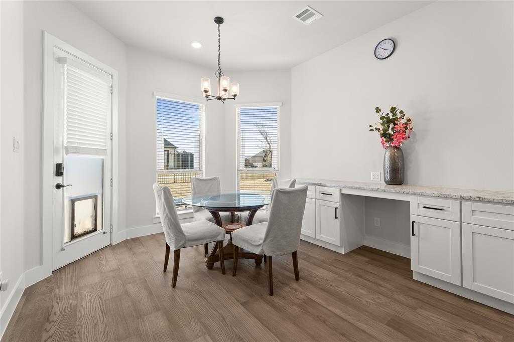 600 St Andrew Lane Prosper, TX 75078 - Photo 9 of 29 Dining room with dark wood-type flooring, built in study area, and suspended lighting