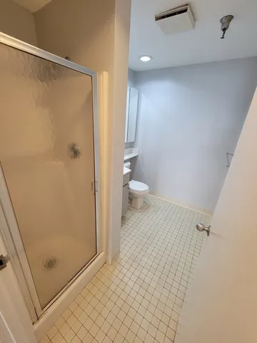 a bathroom with a shower and a toilet