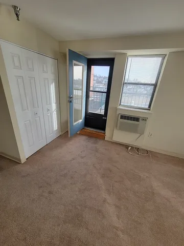 an empty room with windows and closet