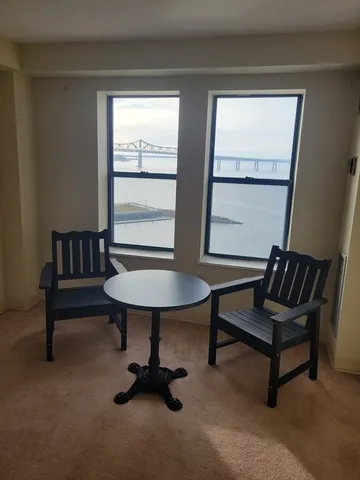 a view of a livingroom with furniture and a window