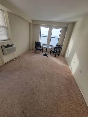 a view of a livingroom with a hardwood floor and a window