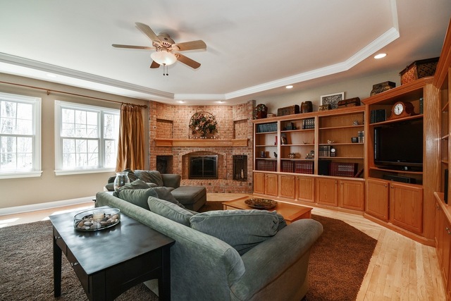 37W571 Grey Barn Road St. Charles, IL 60175 - Photo 10 of 31 a living room with furniture a flat screen tv and a fireplace