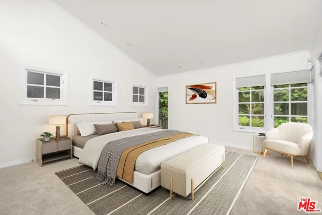 a spacious bedroom with a bed and a couch