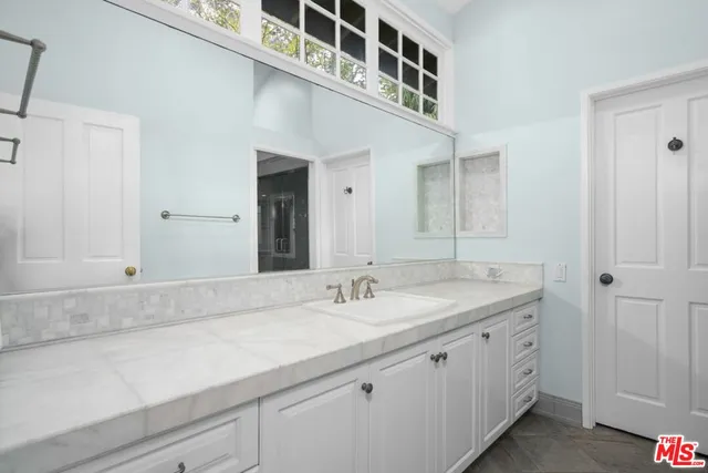 a bathroom with a sink and a mirror