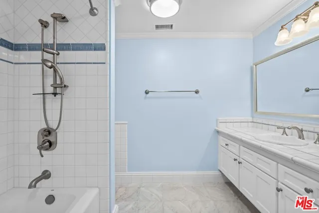 a bathroom with a shower sink and mirror