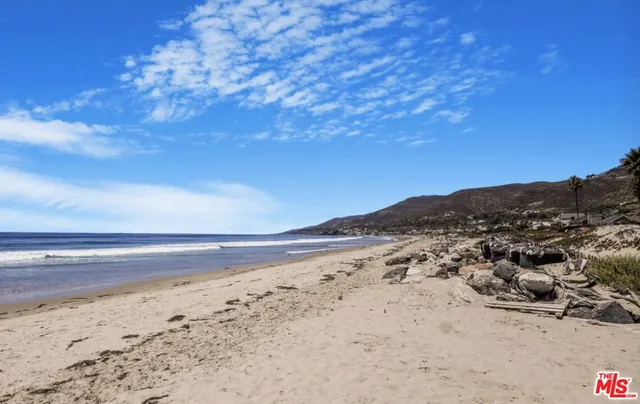 a view of ocean beach and mountain