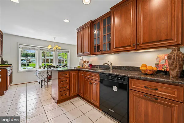 a kitchen with stainless steel appliances granite countertop a stove sink and cabinets