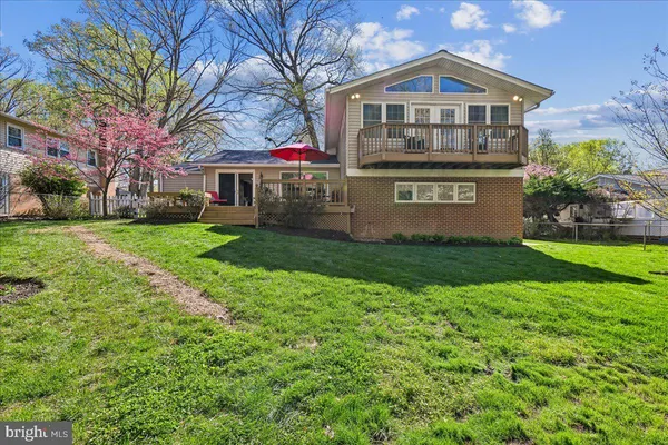 a front view of a house with yard and green space