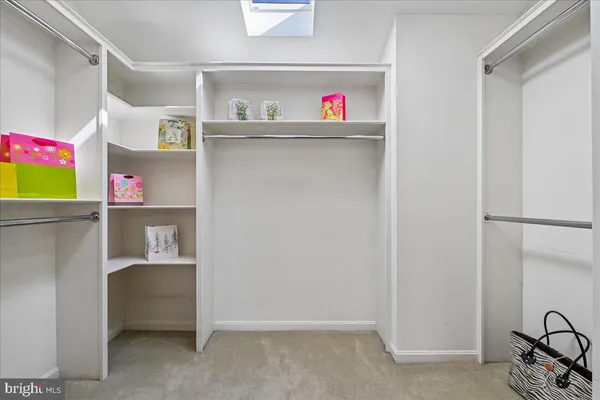 a view of a room with wooden floor table and a lamp
