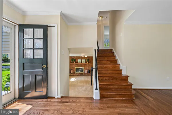 a view of entryway and hall with wooden floor